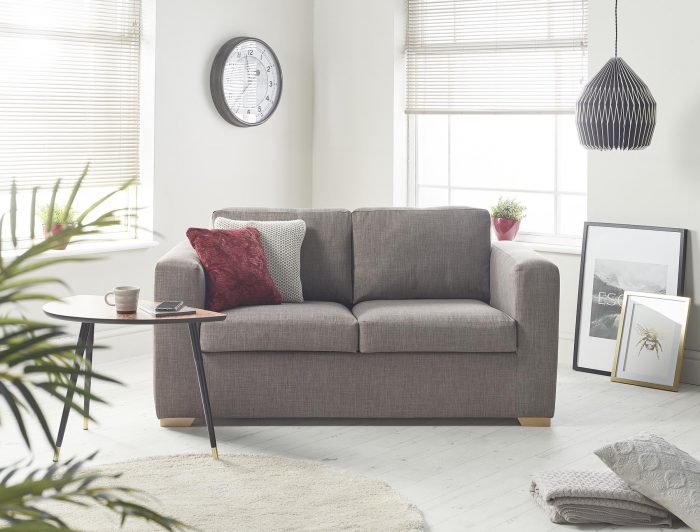 Contemporary two-seater sofabed with scatter cushions